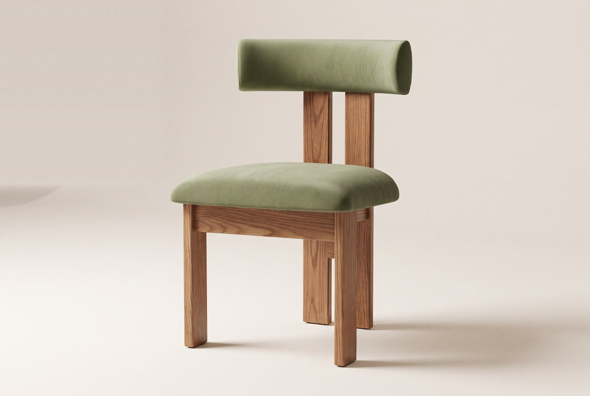 A Carlo oak dining chair with a sage-olive velvet bolster back and seat, front three-quarter view on an off-white background
