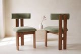 Two Carlo dining chairs in olive velvet and oak, one seen from the front and one from behind