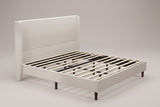 Carrara wingback bed in beige chenille, three-quarter view of the bare frame with wood slats on tapered wood legs