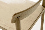 Close-up of the Casole back panel in natural oak: the layered plywood edge and the round post set into it