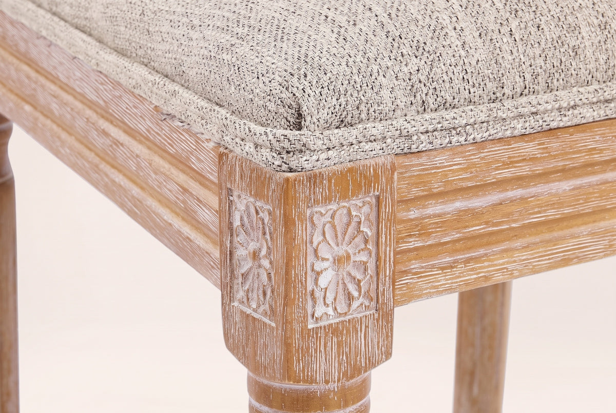 Close-up of a carved rosette corner block, the reeded seat rail, a turned front leg and the Beige seat edge
