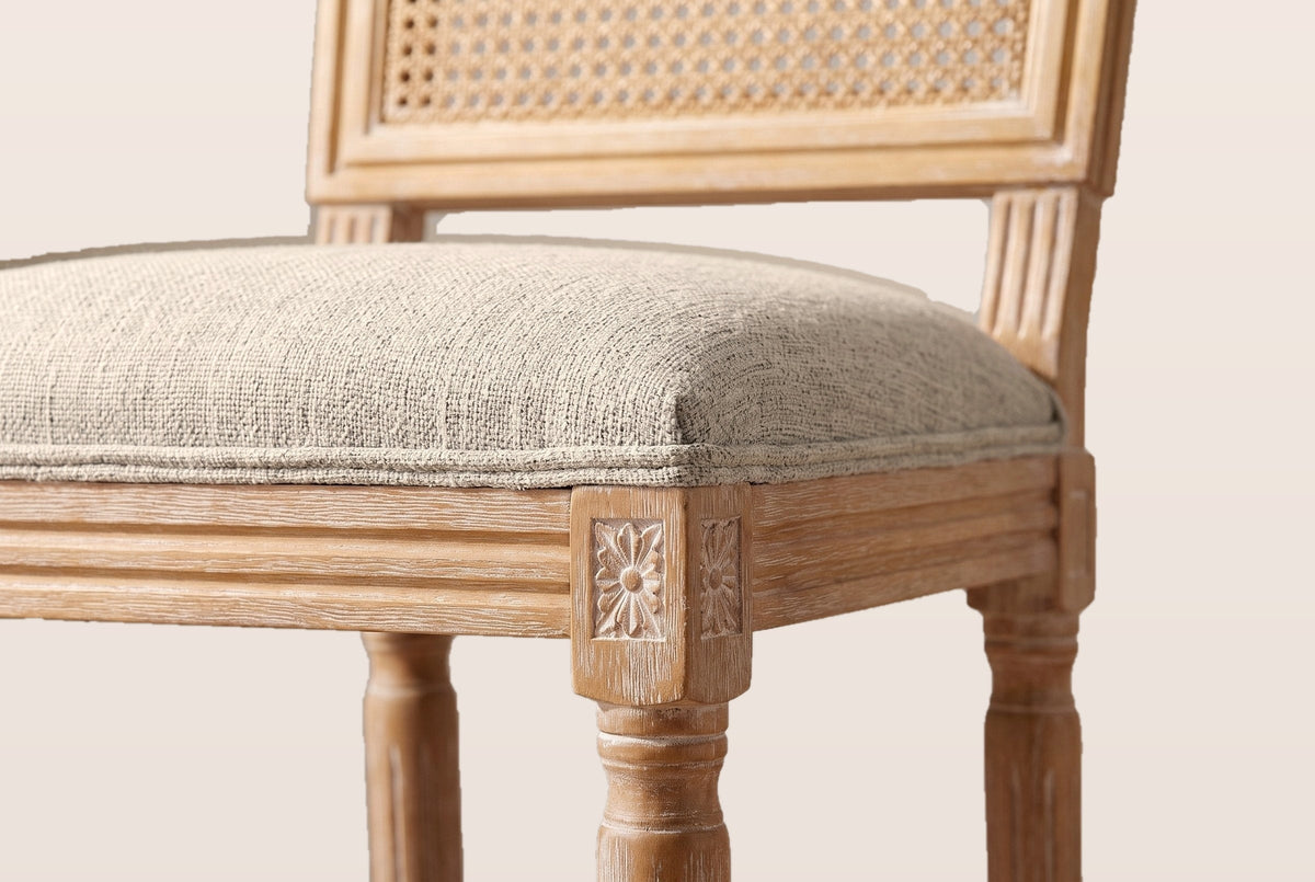 Close-up of the Beige linen-look seat, the reeded rail and the carved rosette on a front corner block