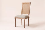 Castelfranco French cane-back dining chair in Beige, three-quarter view on a warm off-white backdrop