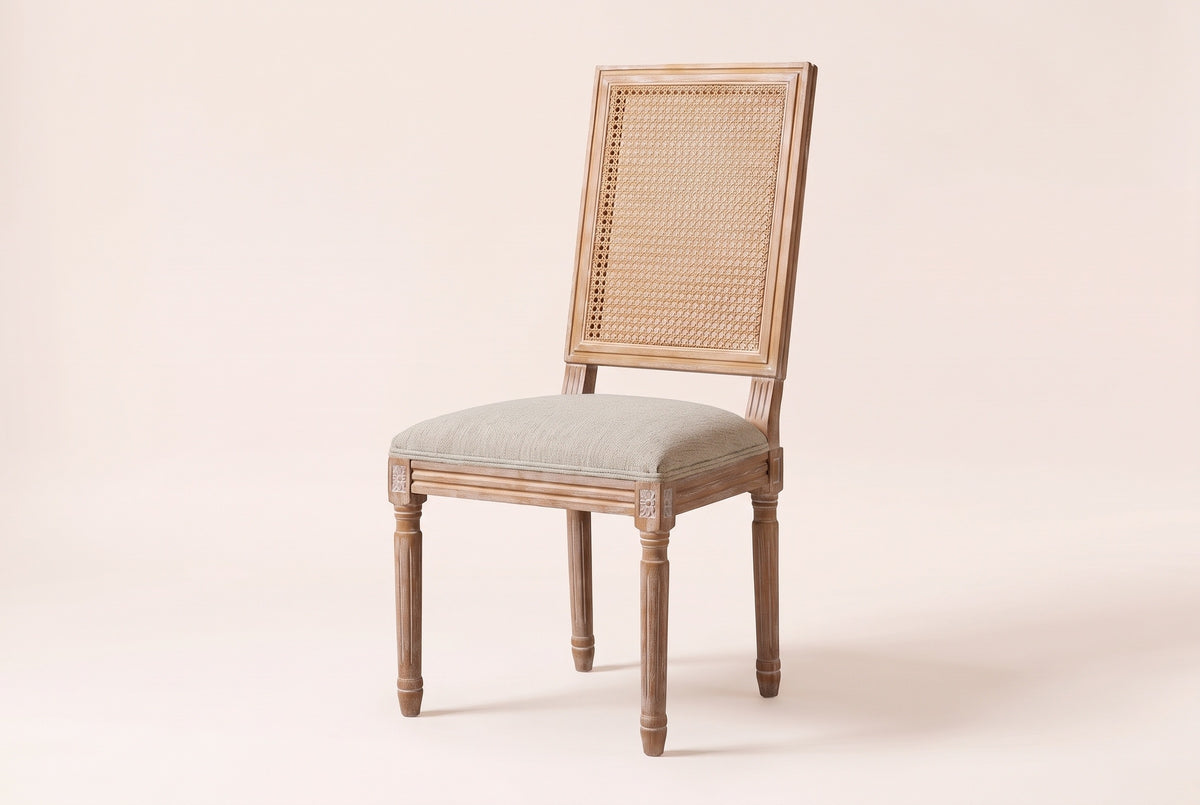Castelfranco French cane-back dining chair in Beige, three-quarter view on a warm off-white backdrop