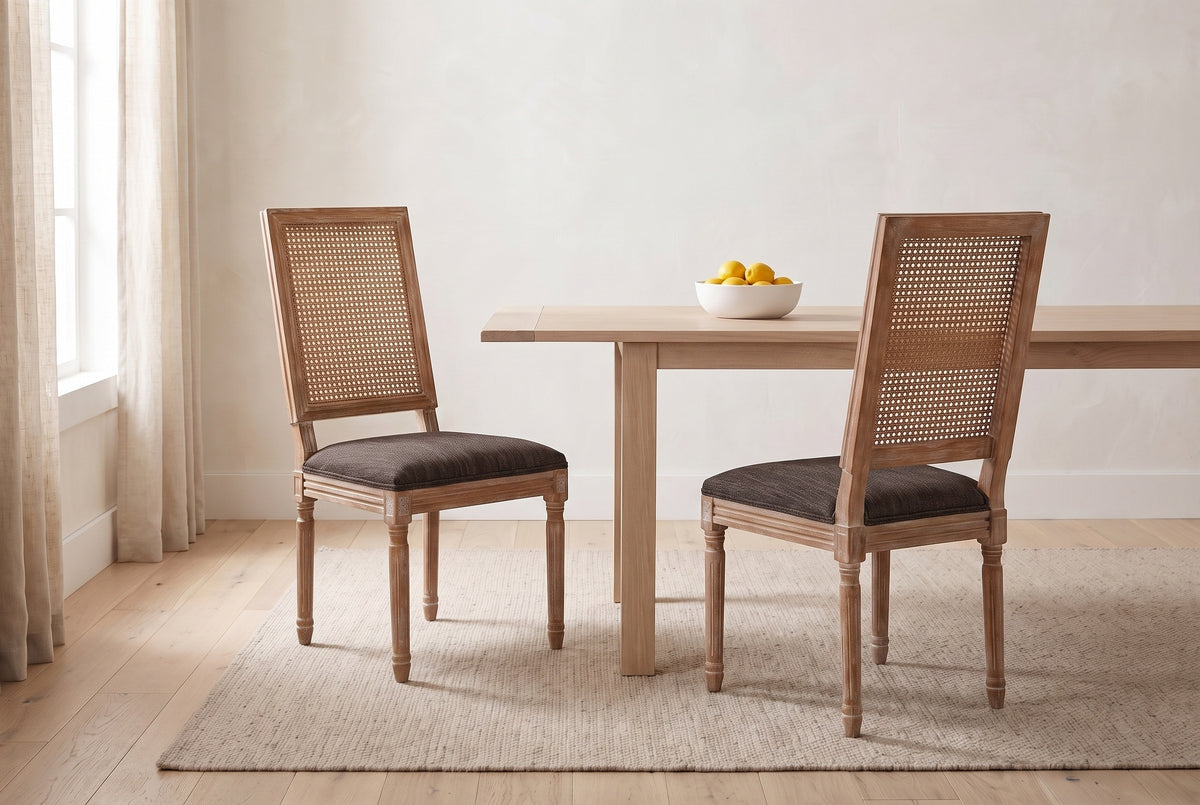 A pair of Castelfranco dining chairs in Brown in a bright Vancouver dining nook with a pale oak table and a bowl of lemons