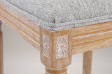 Close-up of a carved rosette corner block, the reeded seat rail and a turned front leg