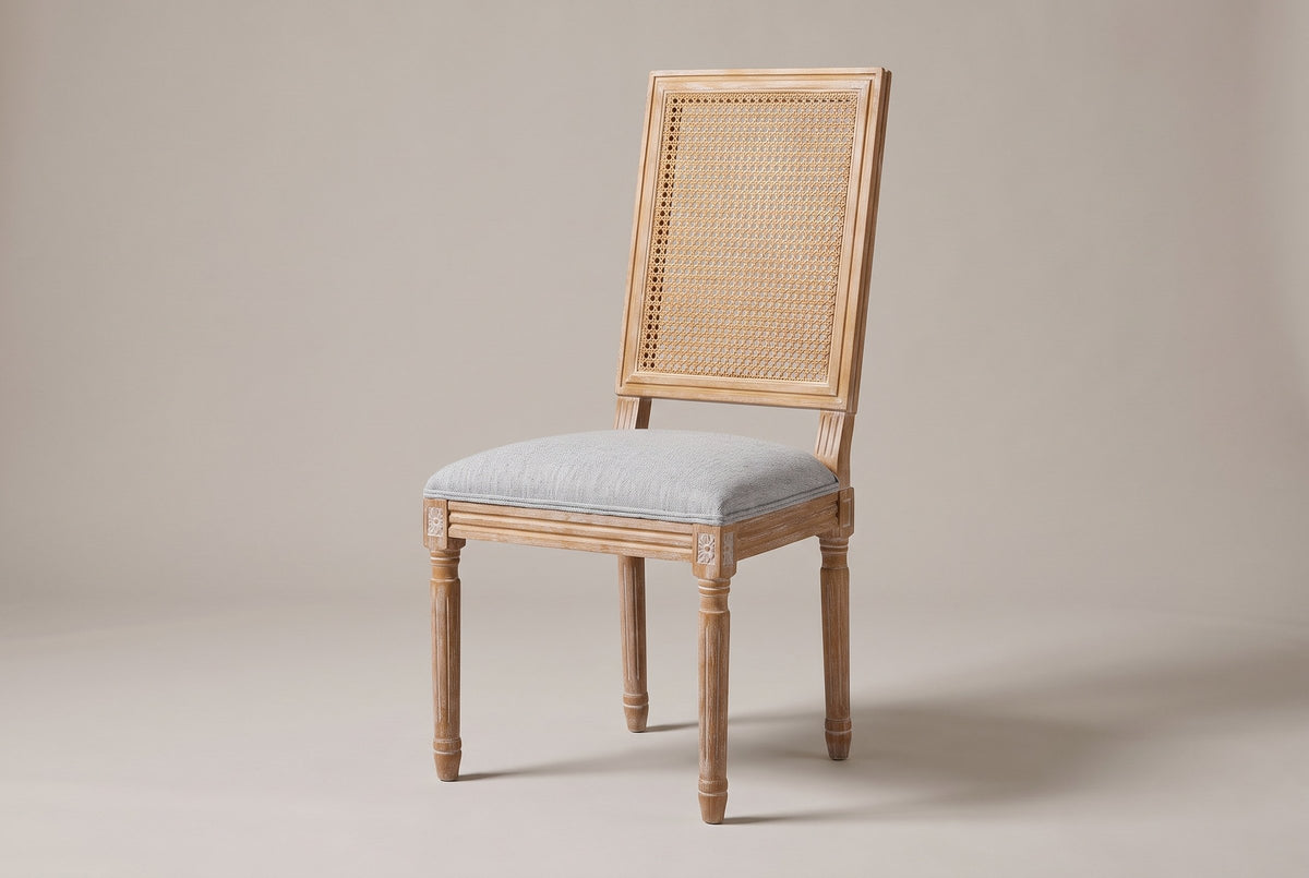 Castelfranco French cane-back dining chair in Light Grey, three-quarter view on a warm light-grey studio backdrop