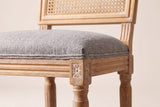 Close-up of the Mid Grey linen-look seat, the reeded rail and the carved rosette on a front corner block