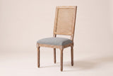 Castelfranco French cane-back dining chair in Mid Grey, three-quarter view on a warm off-white backdrop
