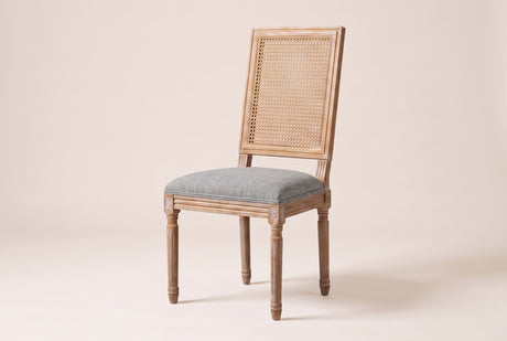 Castelfranco French cane-back dining chair in Mid Grey, three-quarter view on a warm off-white backdrop