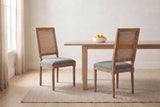 A pair of Castelfranco dining chairs in Mid Grey in a bright Vancouver dining nook with a pale oak table and a bowl of lemons