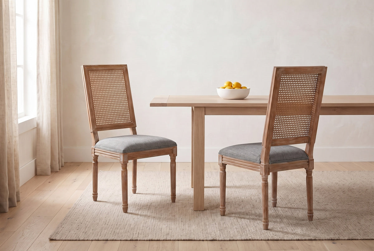 A pair of Castelfranco dining chairs in Mid Grey in a bright Vancouver dining nook with a pale oak table and a bowl of lemons