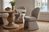 Castellabate dining chairs in beige around a round pine pedestal table in a whitewashed Muskoka cottage