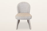 Castellabate dining chair in beige, straight front view: the rounded back, the thick seat and the two flared side panels