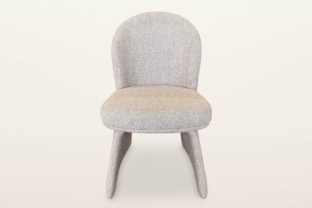 Castellabate dining chair in beige, straight front view: the rounded back, the thick seat and the two flared side panels