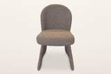Castellabate dining chair in brown, straight front view: the rounded back, the thick seat and the two flared side panels