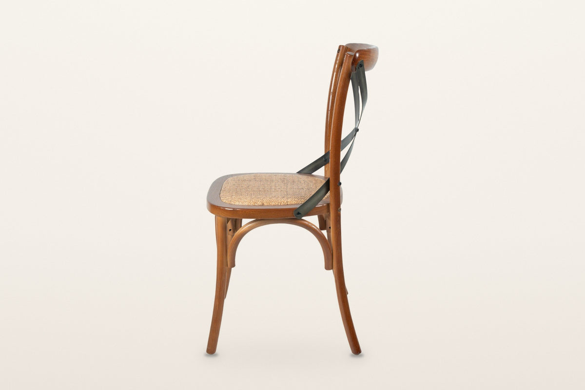 Castelmola dining chair in Brown, side view on a warm white studio backdrop