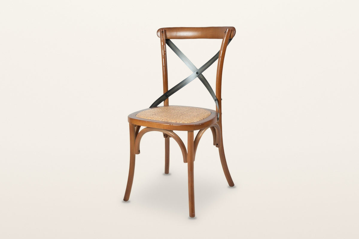 Castelmola cross back dining chair in Brown, three-quarter view on a warm white studio backdrop