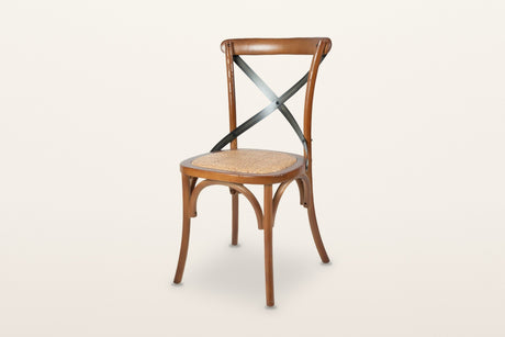 Castelmola cross back dining chair in Brown, three-quarter view on a warm white studio backdrop