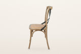 Castelmola dining chair in Natural Rustic, side view on a warm white studio backdrop