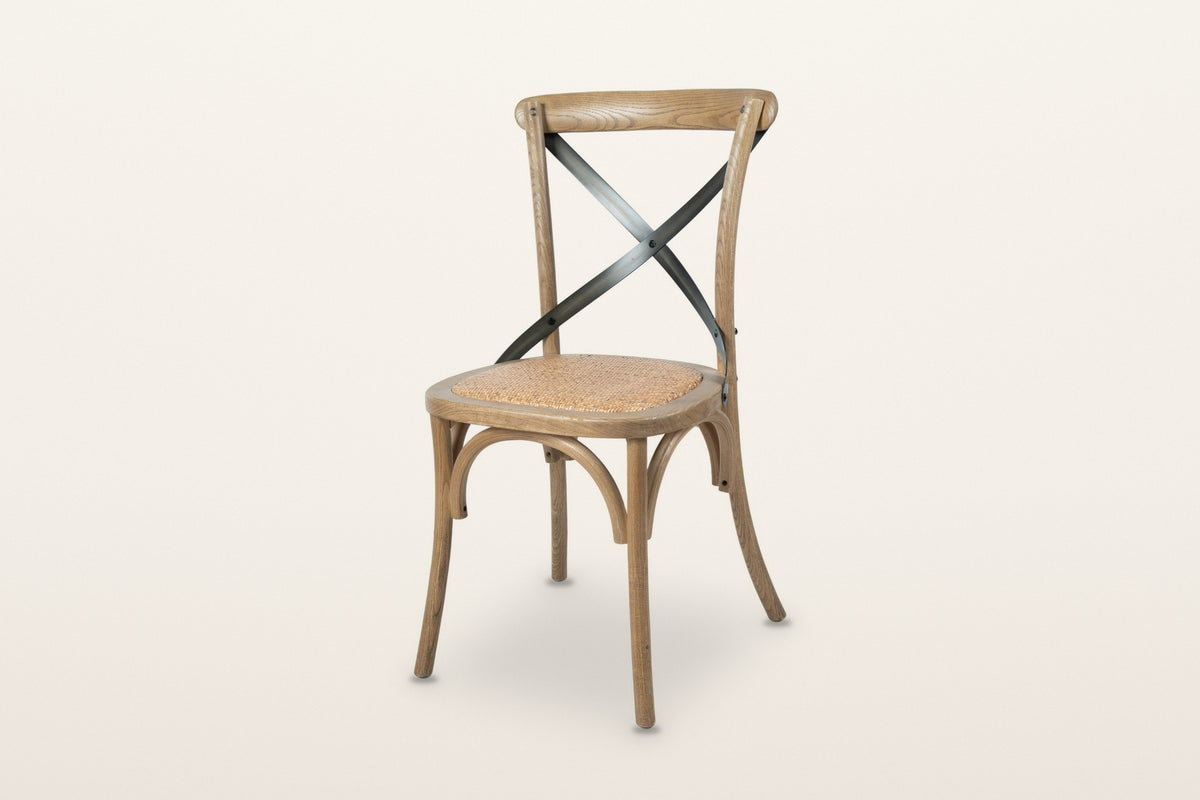 Castelmola cross back dining chair in Natural Rustic, three-quarter view on a warm white studio backdrop