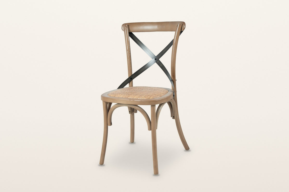 Castelmola cross back dining chair in Sundried, three-quarter view on a warm white studio backdrop: bentwood elm frame