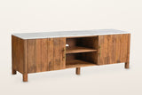 Ceresole 63 in media cabinet in mango wood with a white marble top: two plank doors with aged-gold bar pulls either side of an open centre with one shelf, on round legs, three-quarter view on a warm white studio backdrop