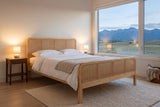 Certaldo cane bed at dusk in a bedroom with a mountain view and two lamps lit