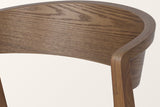 Close-up of the Certosa back band in walnut: ash grain, the layered bent-plywood edge and the rear leg meeting the band