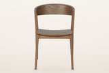 Certosa dining chair in walnut, straight front: the curved back band, the dished seat and four tapered legs