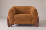 Cervia lounge chair in Caramel boucle, straight front view on a studio backdrop