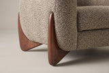 Close-up of a carved triangular birch leg in walnut finish at the corner of the Cervia arm