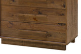 Close-up of the Cervinia chest's lower drawers, the frame rail and the low plinth set back beneath the case