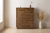 Cervinia reclaimed pine chest straight on against an off-white plaster wall in a Glebe, Ottawa bedroom, dried pampas grass beside it