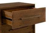 Close-up of an open Cervinia drawer: the plank front, the square wooden bar pull and the metal ball-bearing runner on the side