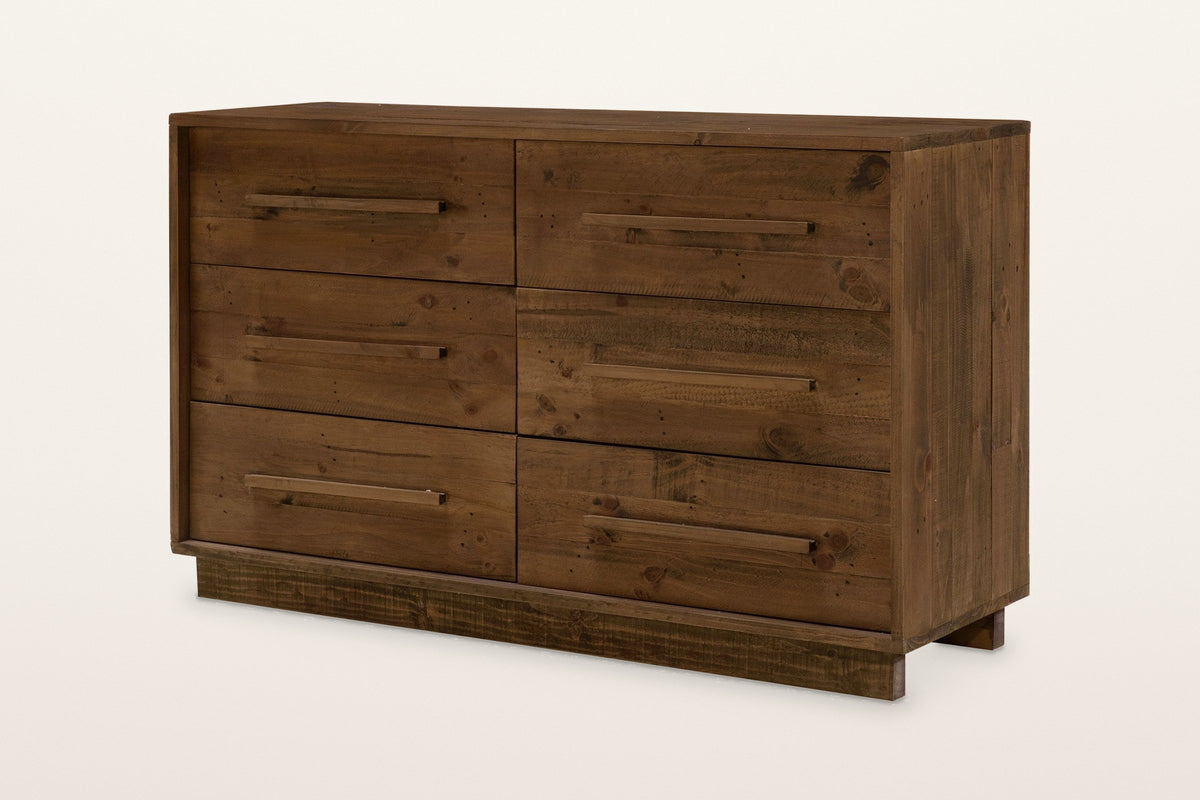 Cervinia 6-drawer dresser in weathered brown reclaimed pine: two columns of three plank drawers, one wooden bar pull on each, on a recessed plinth, three-quarter view on a warm white studio backdrop
