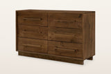 Cervinia 6-drawer dresser in weathered brown reclaimed pine: two columns of three plank drawers, one wooden bar pull on each, on a recessed plinth, three-quarter view on a warm white studio backdrop
