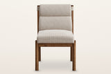 Cervo dining chair, straight front view: a padded back between two round walnut posts, a thick woven seat, four round legs