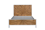 Cesana bed seen from the foot end: the pine sunburst headboard above the slats and the low sunburst footboard in a white frame