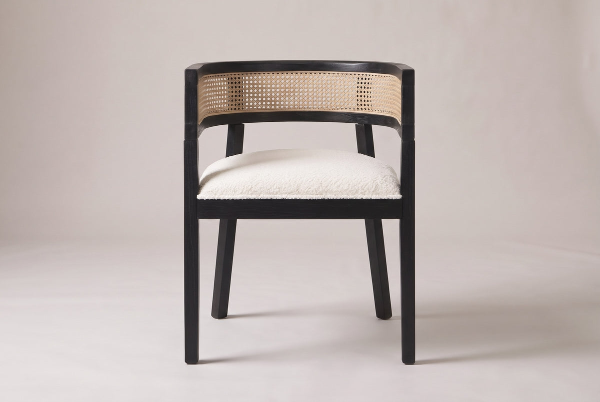 Cesena dining chair in Black, straight front view showing the barrel back, the cane-look band and four legs