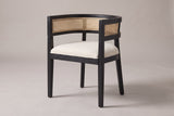Cesena cane-back dining chair in Black, three-quarter view on a warm light-grey studio backdrop