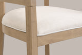 Close-up of the welted linen-look seat, the wood seat frame and a tapered front leg of the Natural Ash Cesena chair