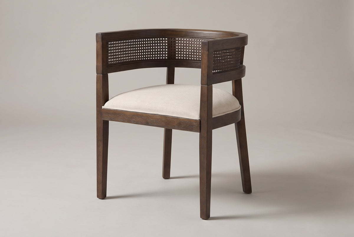 Cesena cane-back dining chair in Walnut, three-quarter view on a warm light-grey studio backdrop