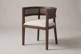 Cesena cane-back dining chair in Walnut, three-quarter view on a warm light-grey studio backdrop