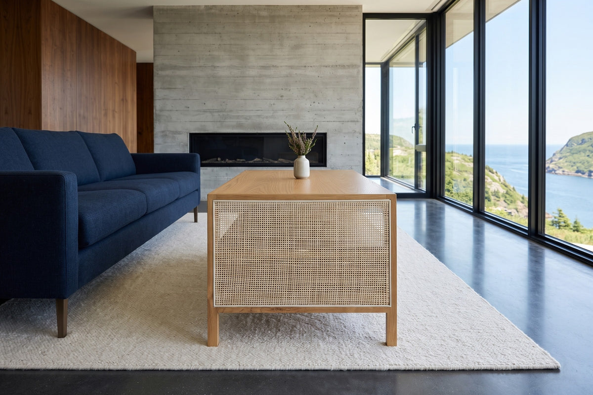 End view of the Cetara coffee table in Natural ash and wicker in a St. John's house above the Narrows