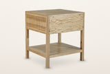 Back of the Cetara side table in Natural on a warm white studio backdrop: a plain oak veneer back panel
