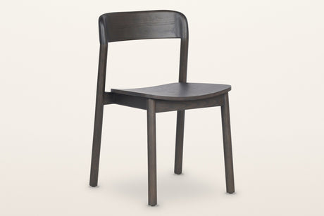 Chiavenna curved-back dining chair in mocha, three-quarter view on a warm white studio backdrop