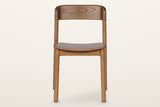 Chiavenna dining chair in walnut, straight front view: the curved back rail, the thin seat and four round legs