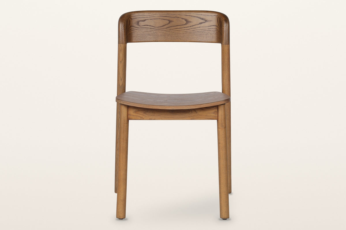 Chiavenna dining chair in walnut, straight front view: the curved back rail, the thin seat and four round legs
