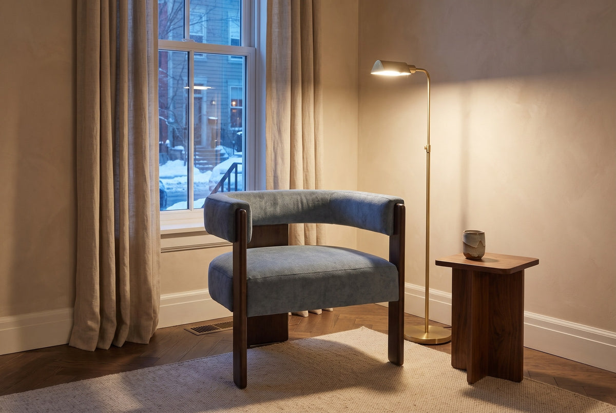 Chioggia accent chair in a townhouse reading corner at dusk, a brass floor lamp lit beside it